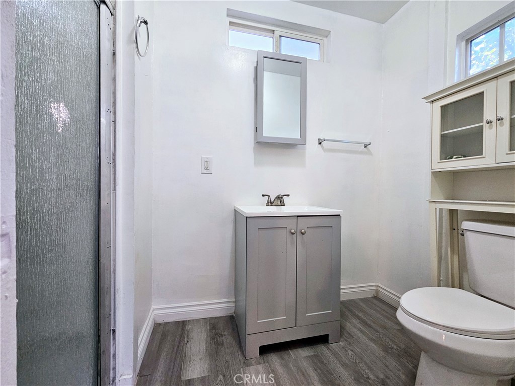 7513 Lurline Avenue Winnetka, CA 91306 - Photo 9 of 9 a bathroom with a sink a toilet and vanity