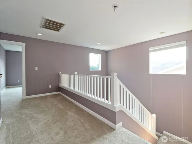 a view of a hallway with windows