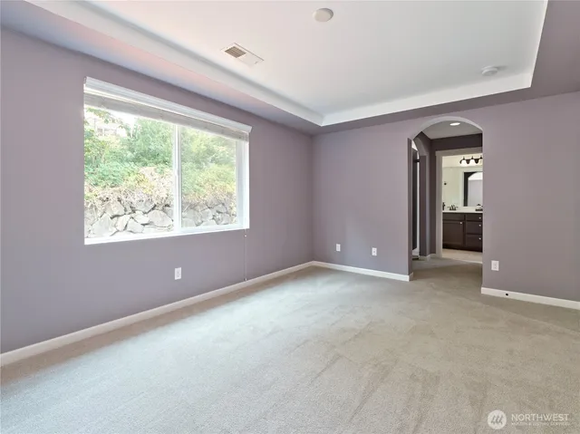 an empty room with a window and doors