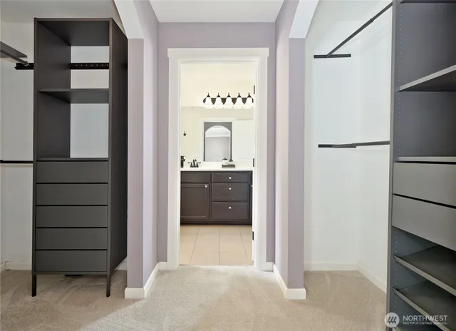 a view of a hallway with closet and cabinet