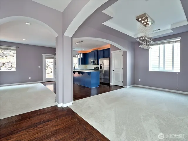 a view of a kitchen with wooden floor and a kitchen