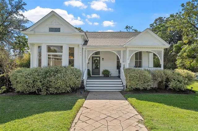 a front view of a house with a garden