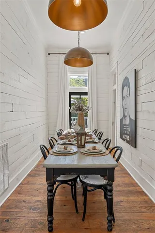 a living room with furniture a flat screen tv and a chandelier