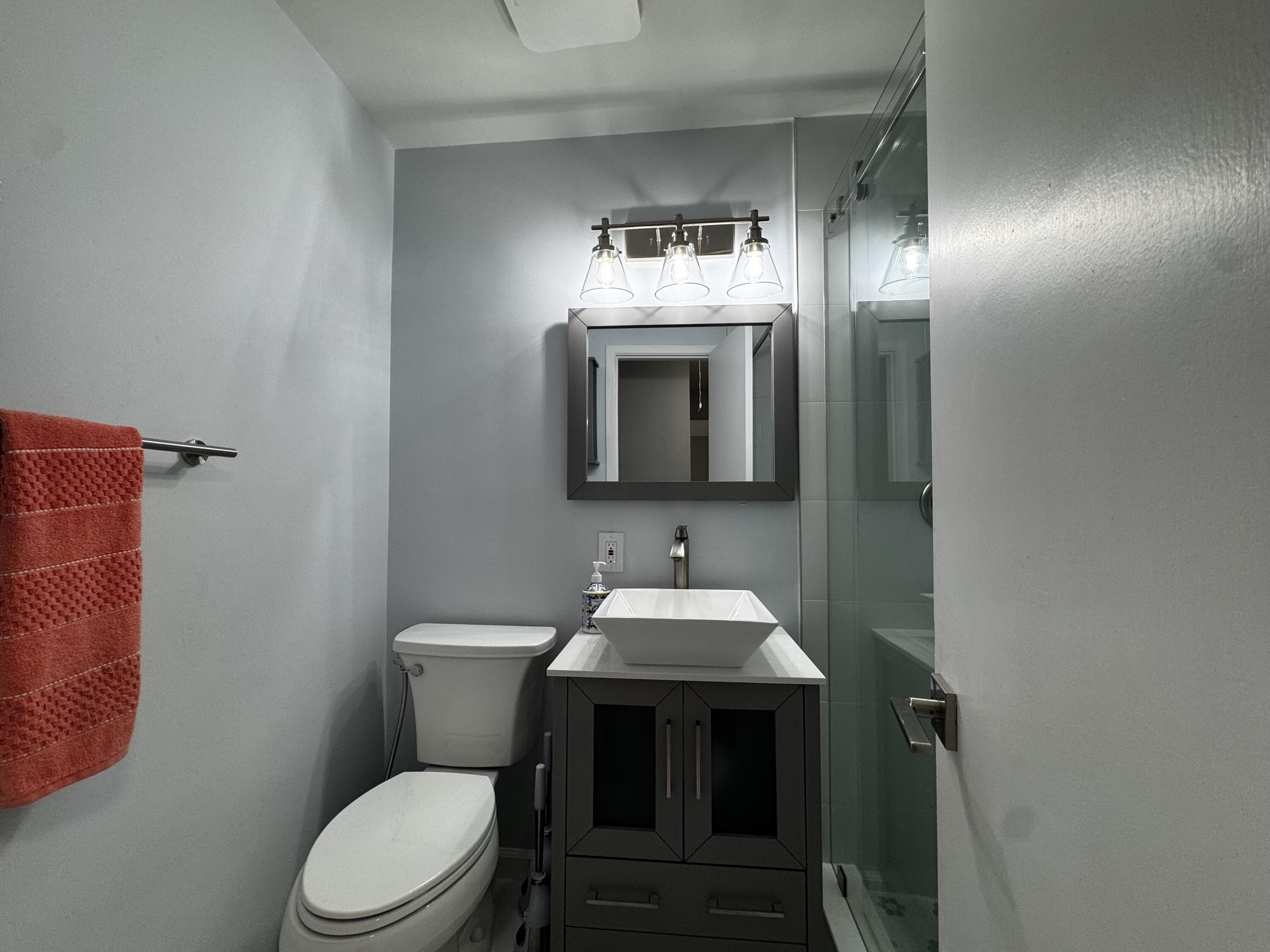 73 East Court, Unit 73 Royal Palm Beach, FL 33411 - Photo 11 of 17 a bathroom with a sink and a toilet