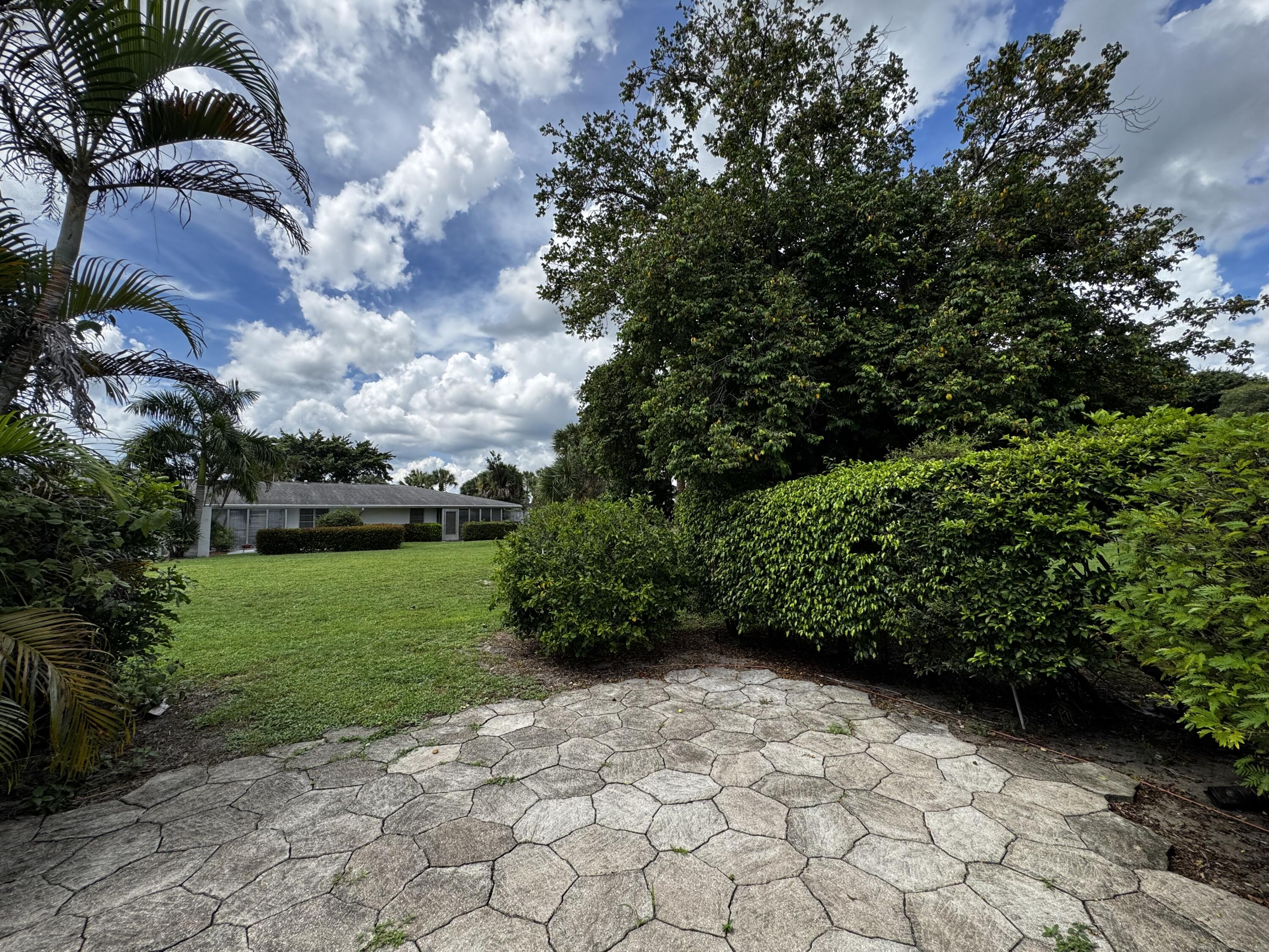 73 East Court, Unit 73 Royal Palm Beach, FL 33411 - Photo 14 of 17 a view of a garden with a fountain