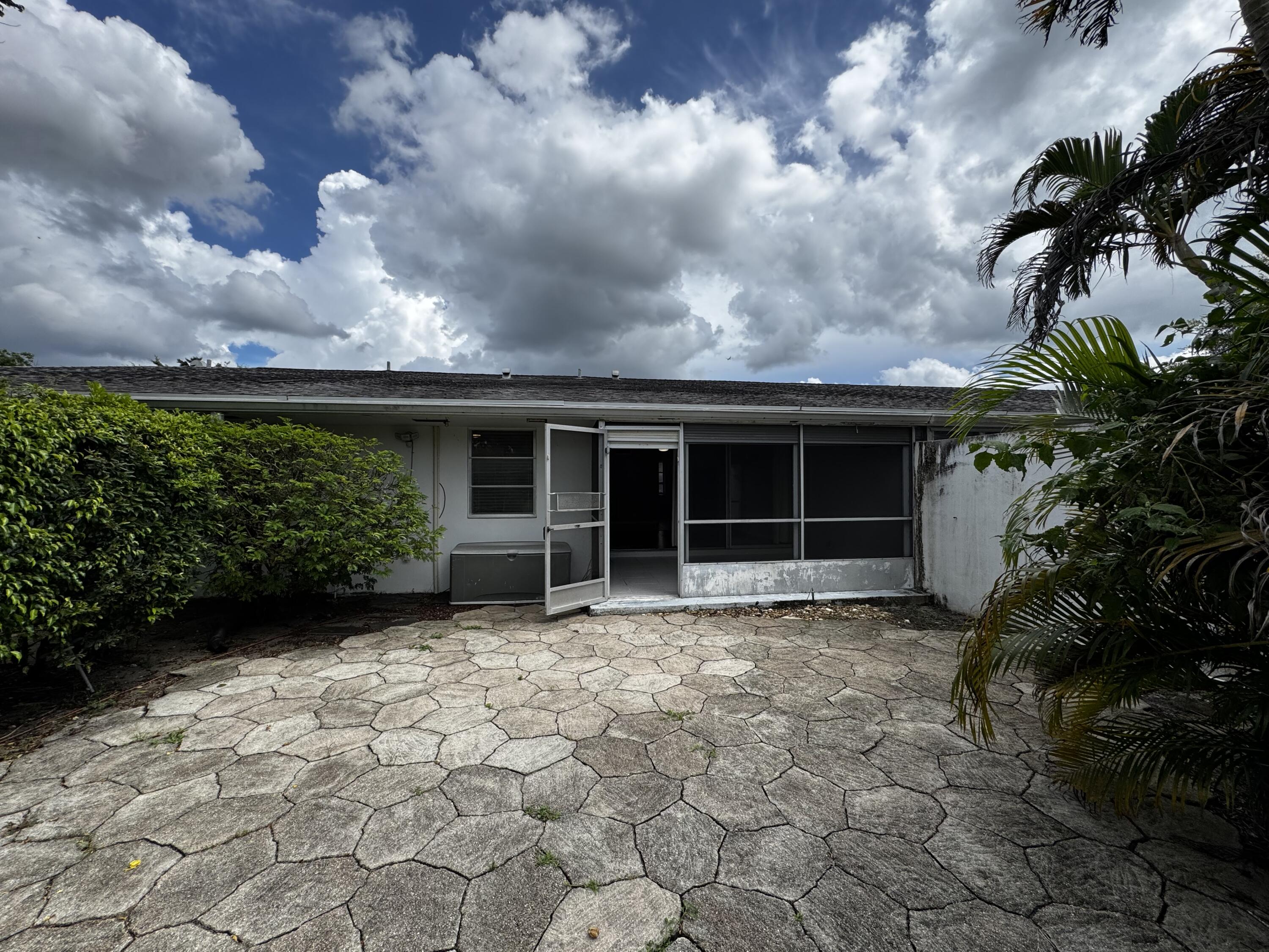 73 East Court, Unit 73 Royal Palm Beach, FL 33411 - Photo 15 of 17 a view of a house with a garden