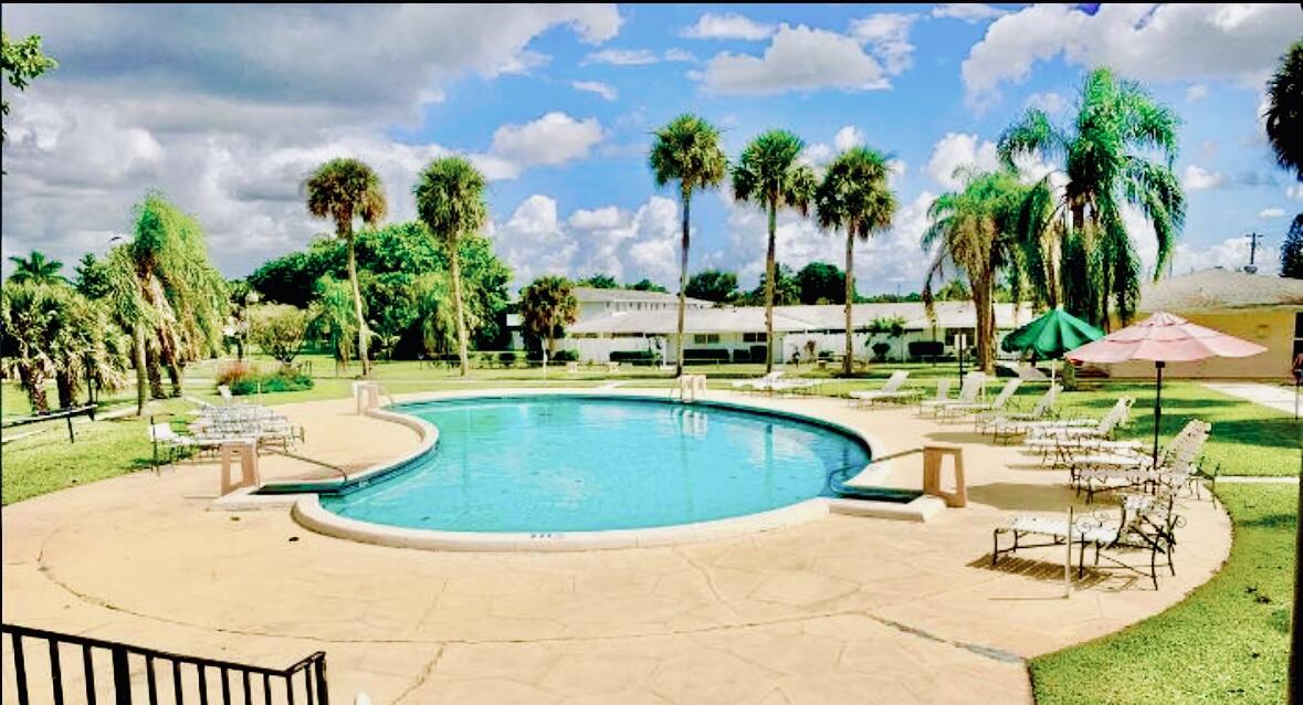 73 East Court, Unit 73 Royal Palm Beach, FL 33411 - Photo 17 of 17 a view of a swimming pool with chairs