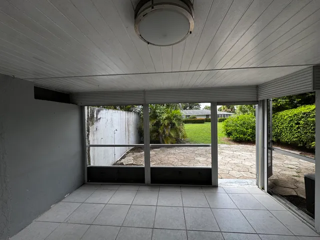 a view of an empty room with a fireplace and a large window