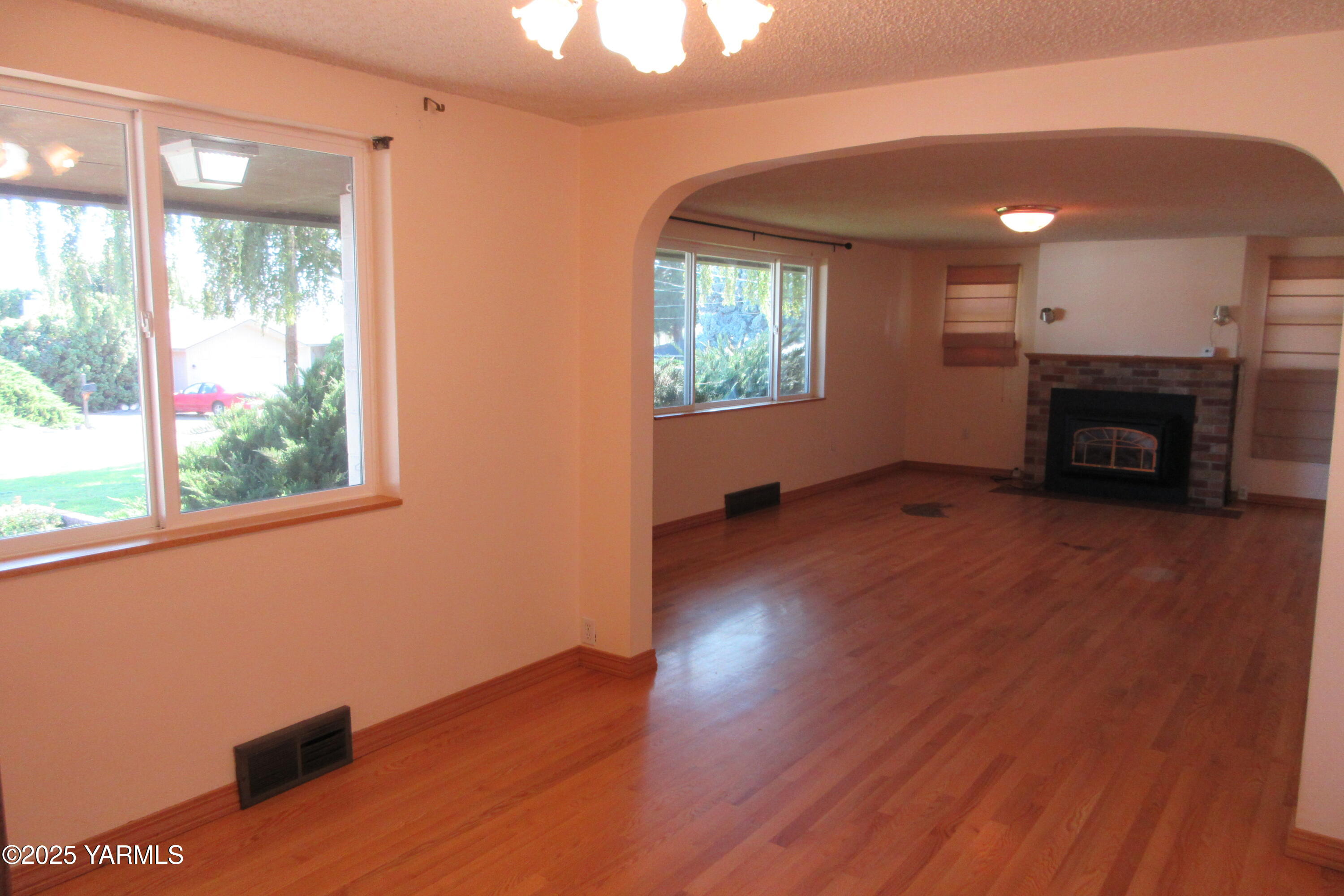 2703 Cascade Road Yakima, WA 98901 - Photo 14 of 24 a view of empty room with wooden floor and a window