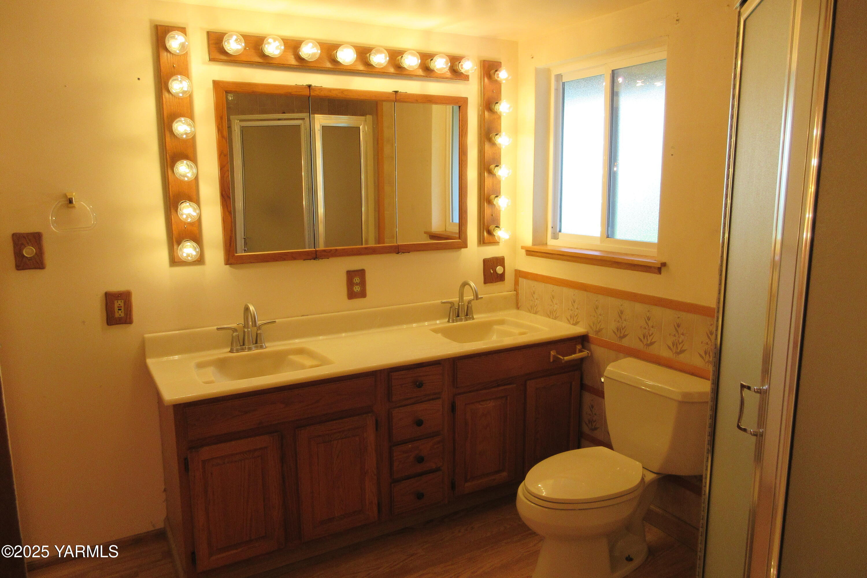 2703 Cascade Road Yakima, WA 98901 - Photo 18 of 24 a bathroom with a granite countertop toilet sink and mirror