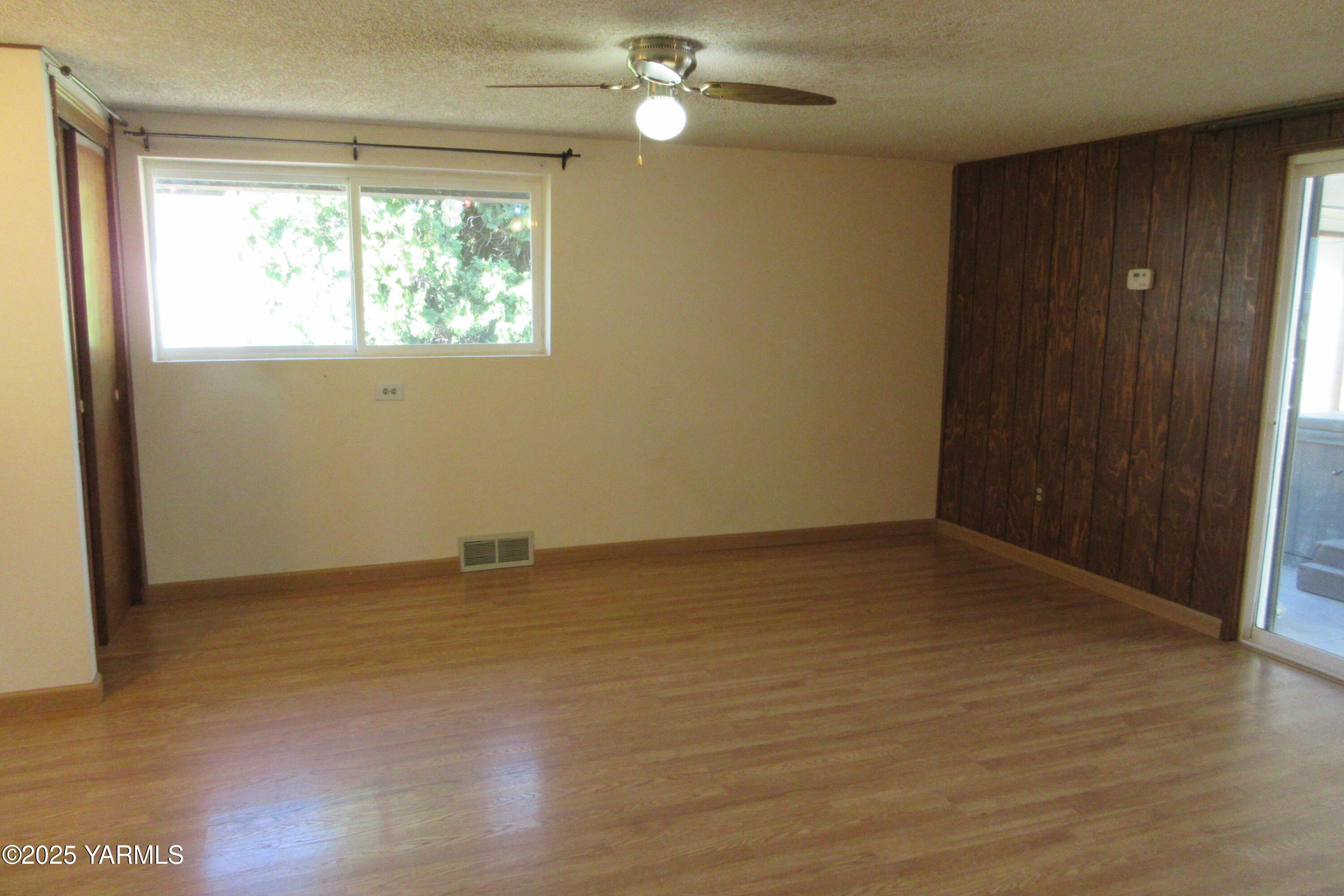 2703 Cascade Road Yakima, WA 98901 - Photo 10 of 24 an empty room with wooden floor and windows