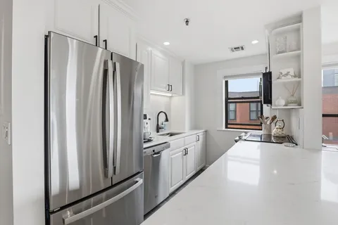 a kitchen with stainless steel appliances a refrigerator sink and stove