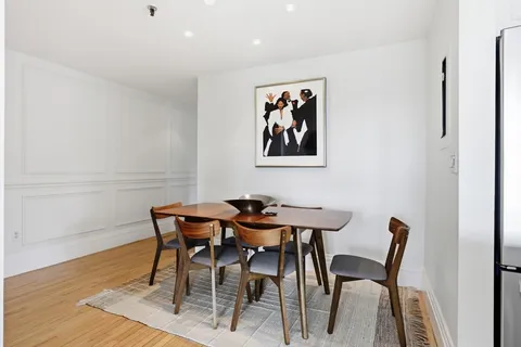 a dining room with furniture and wooden floor