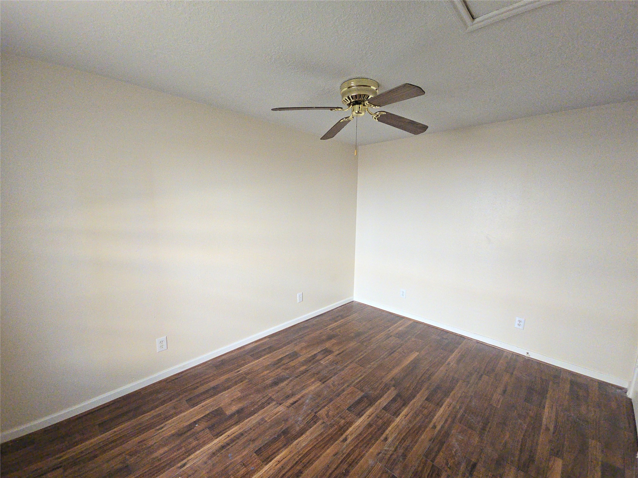 409 Commerce Street Tomball, TX 77375 - Photo 16 of 25 a view of a room with wooden floor and fan