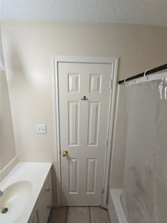 a bathroom with a sink mirror and toilet