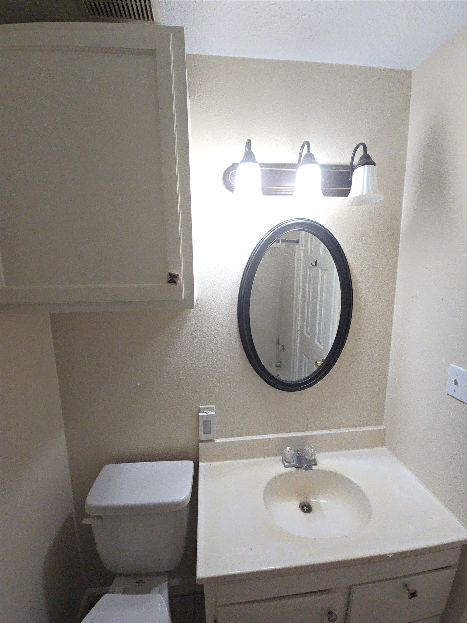409 Commerce Street Tomball, TX 77375 - Photo 18 of 25 a bathroom with a sink mirror and toilet