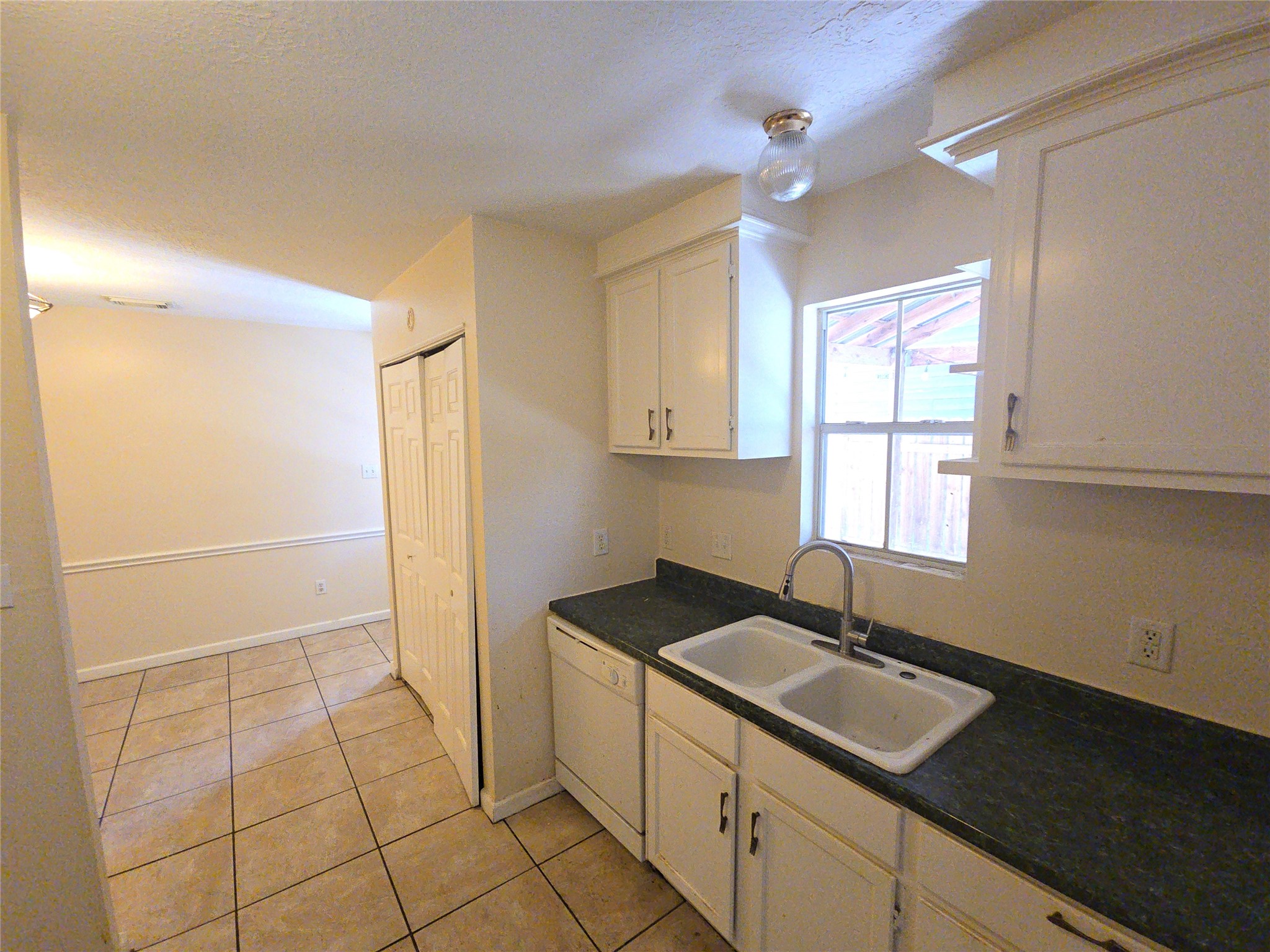 409 Commerce Street Tomball, TX 77375 - Photo 19 of 25 a kitchen with a sink and cabinets