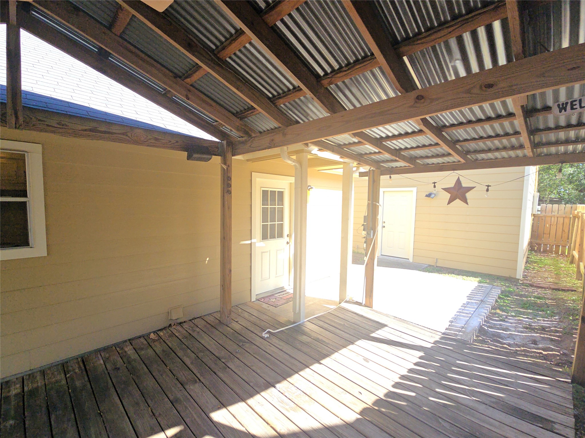 409 Commerce Street Tomball, TX 77375 - Photo 21 of 25 a view of an empty room with wooden floor and a window