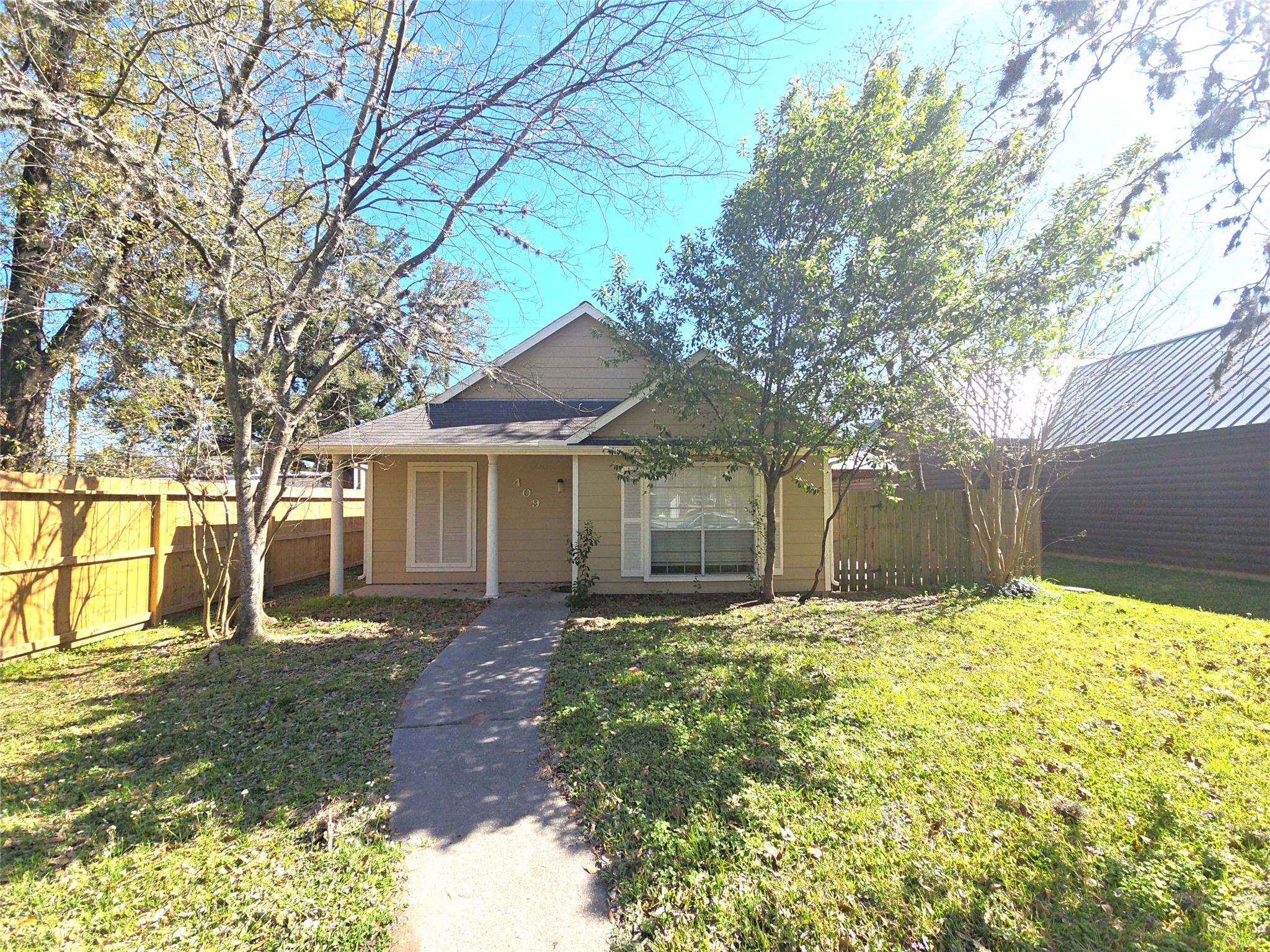 409 Commerce Street Tomball, TX 77375 - Photo 23 of 25 a front view of house with yard and trees around