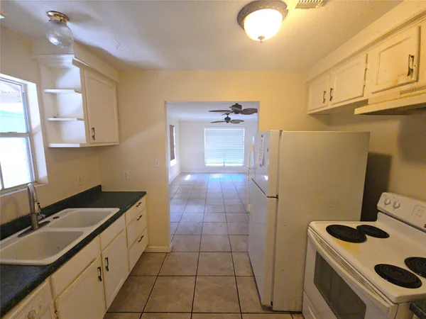 a kitchen with a sink stove and cabinets