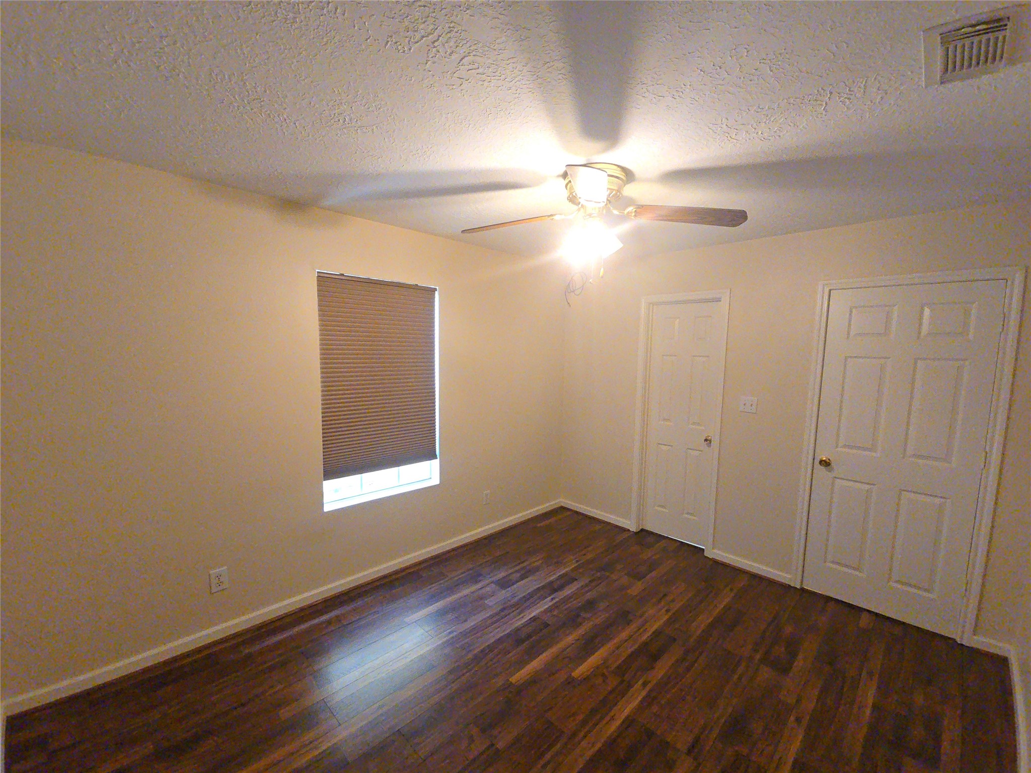 409 Commerce Street Tomball, TX 77375 - Photo 10 of 25 wooden floor in an empty room with a window