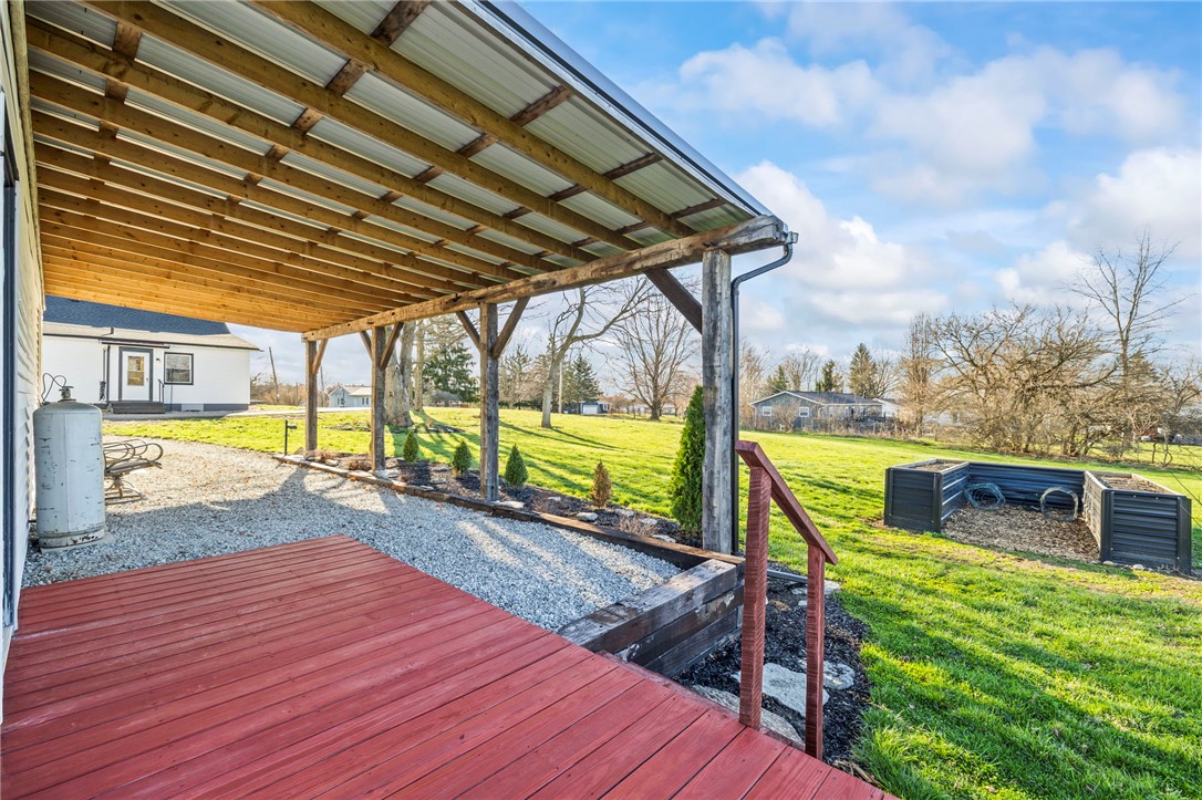 10797 Gratis Jacksonburg Road Somerville, OH 45064 - Photo 21 of 27 This inviting outdoor space features a covered porch overlooking a lush yard, perfect for relaxation.