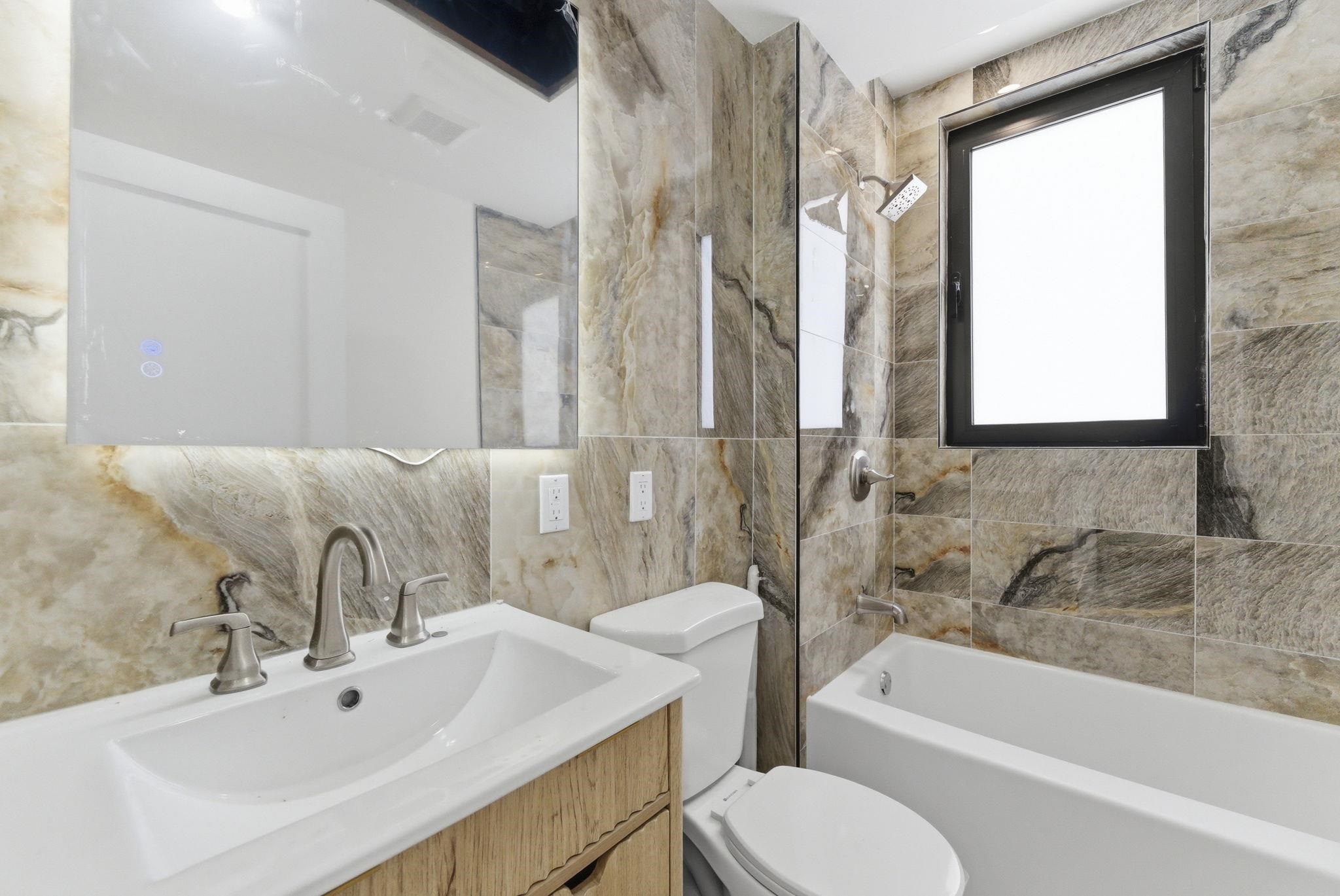 703 3rd Street Secaucus, NJ 07094 - Photo 16 of 49 a bathroom with a sink toilet and bathtub