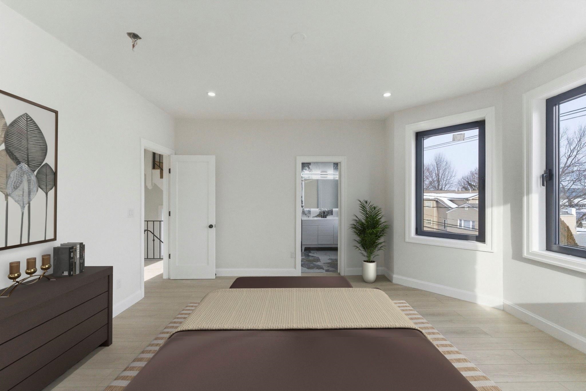 703 3rd Street Secaucus, NJ 07094 - Photo 24 of 49 a spacious bedroom with a large bed and chandelier