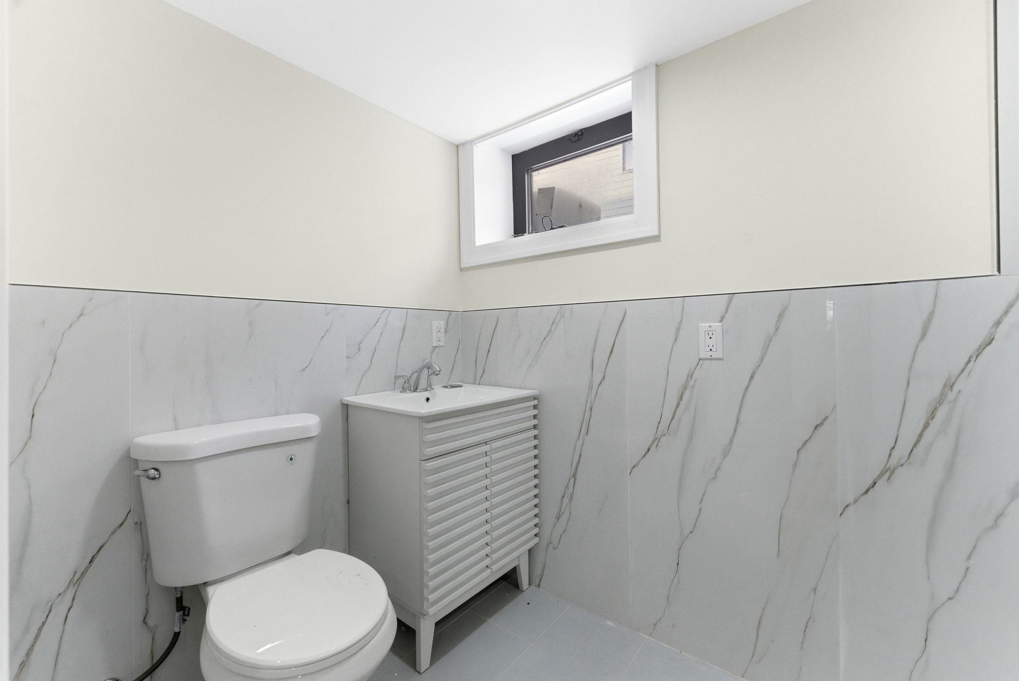 703 3rd Street Secaucus, NJ 07094 - Photo 36 of 49 a white toilet sitting next to a bathroom sink