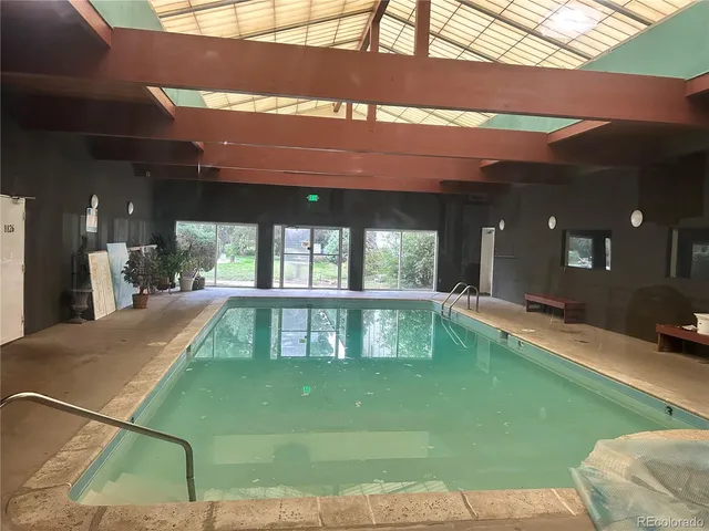 a swimming pool with outdoor seating and yard