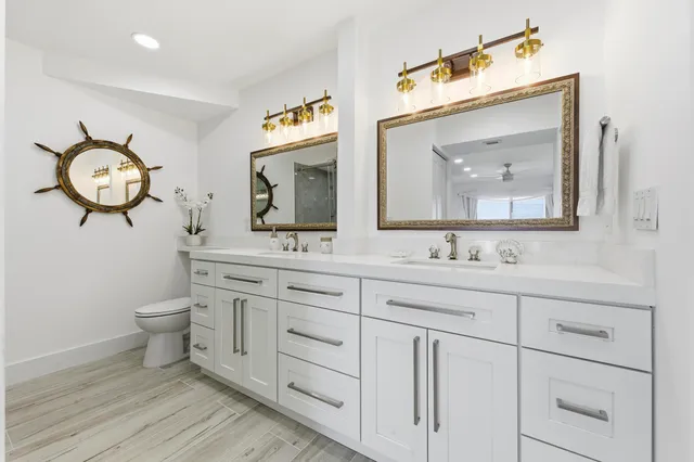 a bathroom with a toilet sink and mirror