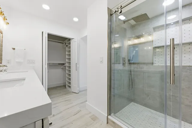a bathroom with a shower and a sink