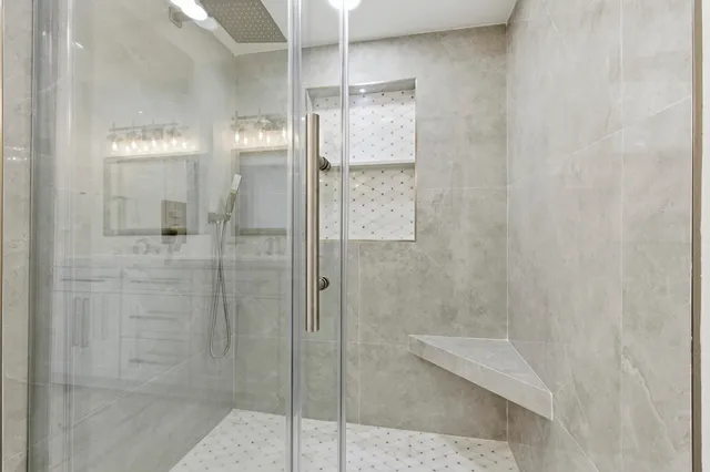 a bathroom with a glass shower door