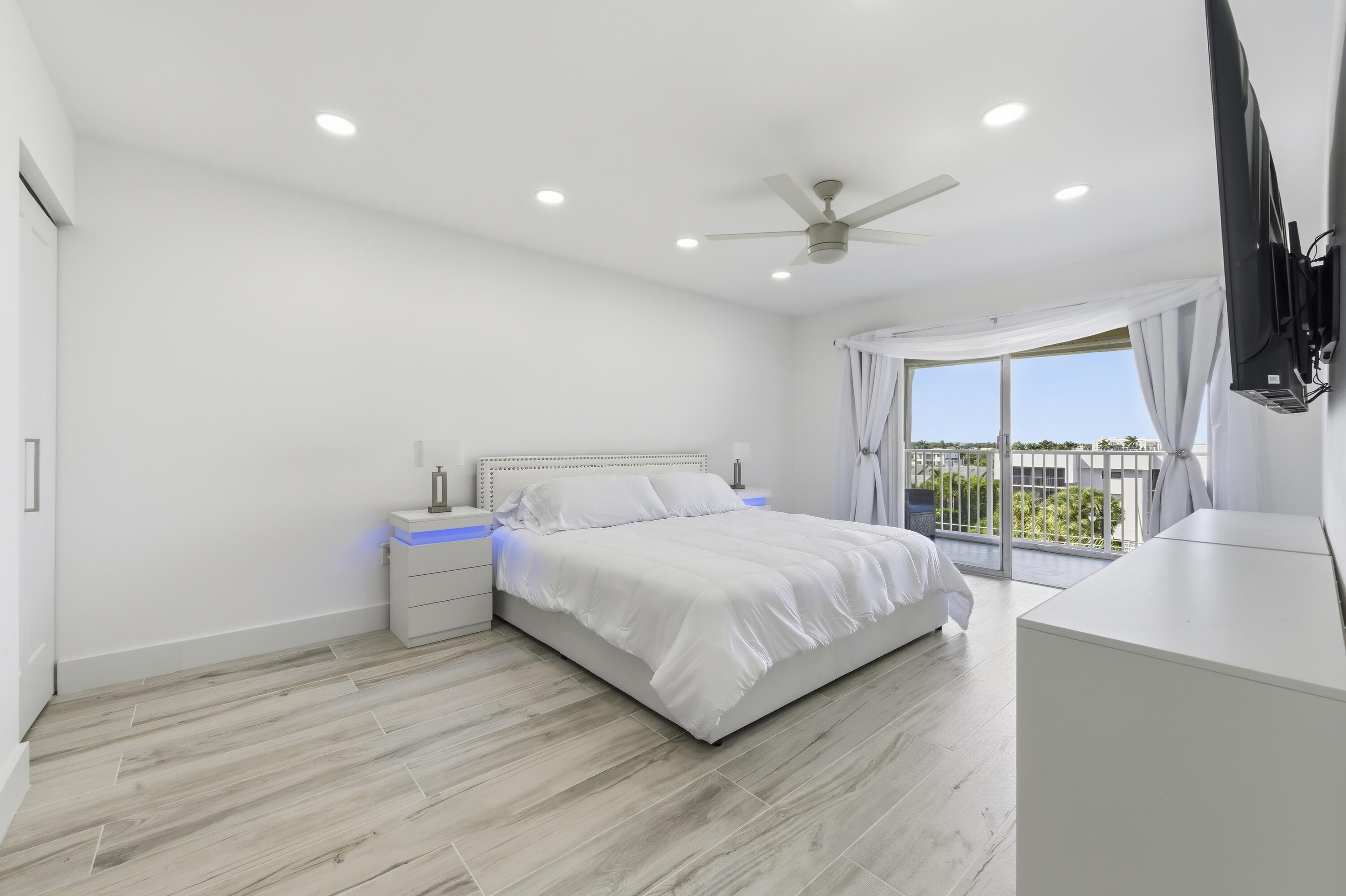3520 South Ocean Boulevard, Unit H502 South Palm Beach, FL 33480 - Photo 14 of 35 a spacious bedroom with a bed and a flat screen tv