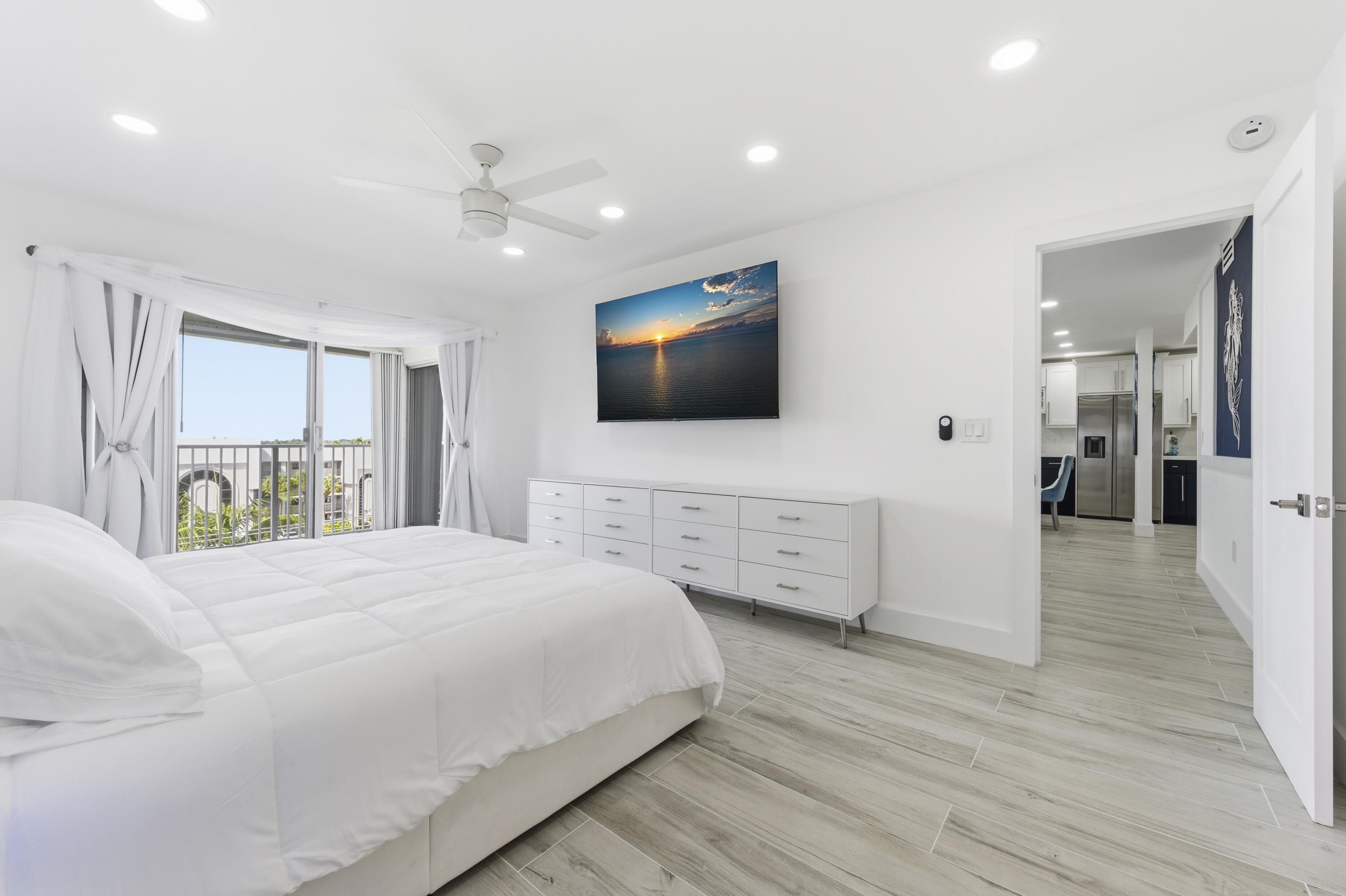 3520 South Ocean Boulevard, Unit H502 South Palm Beach, FL 33480 - Photo 17 of 35 a bedroom with a bed and a flat screen tv