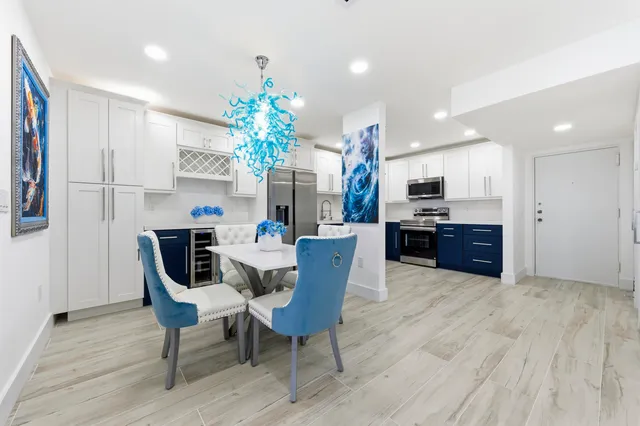 a view of a dining room with furniture and a chandelier