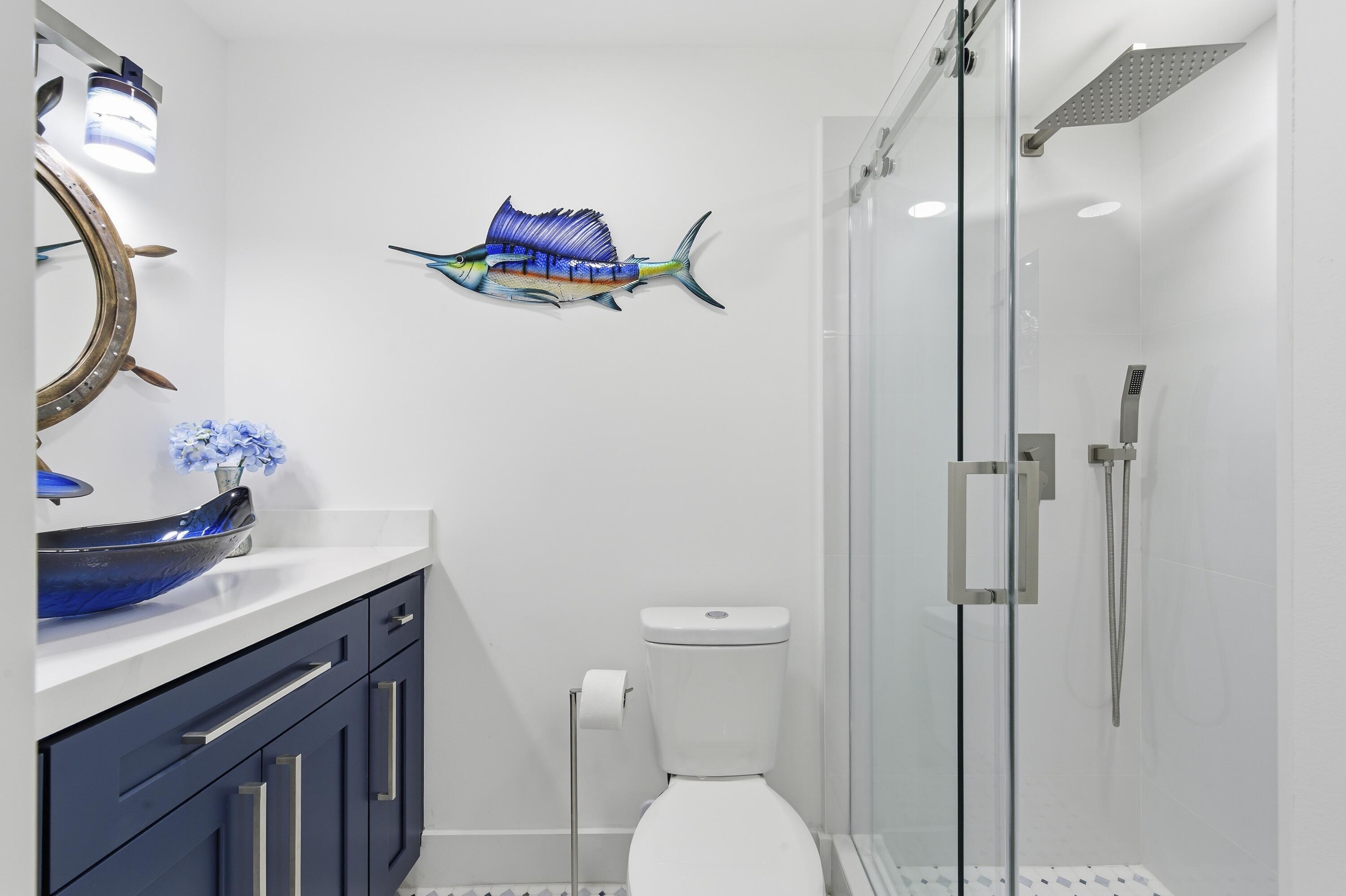 3520 South Ocean Boulevard, Unit H502 South Palm Beach, FL 33480 - Photo 21 of 35 a bathroom with a sink vanity mirror and toilet