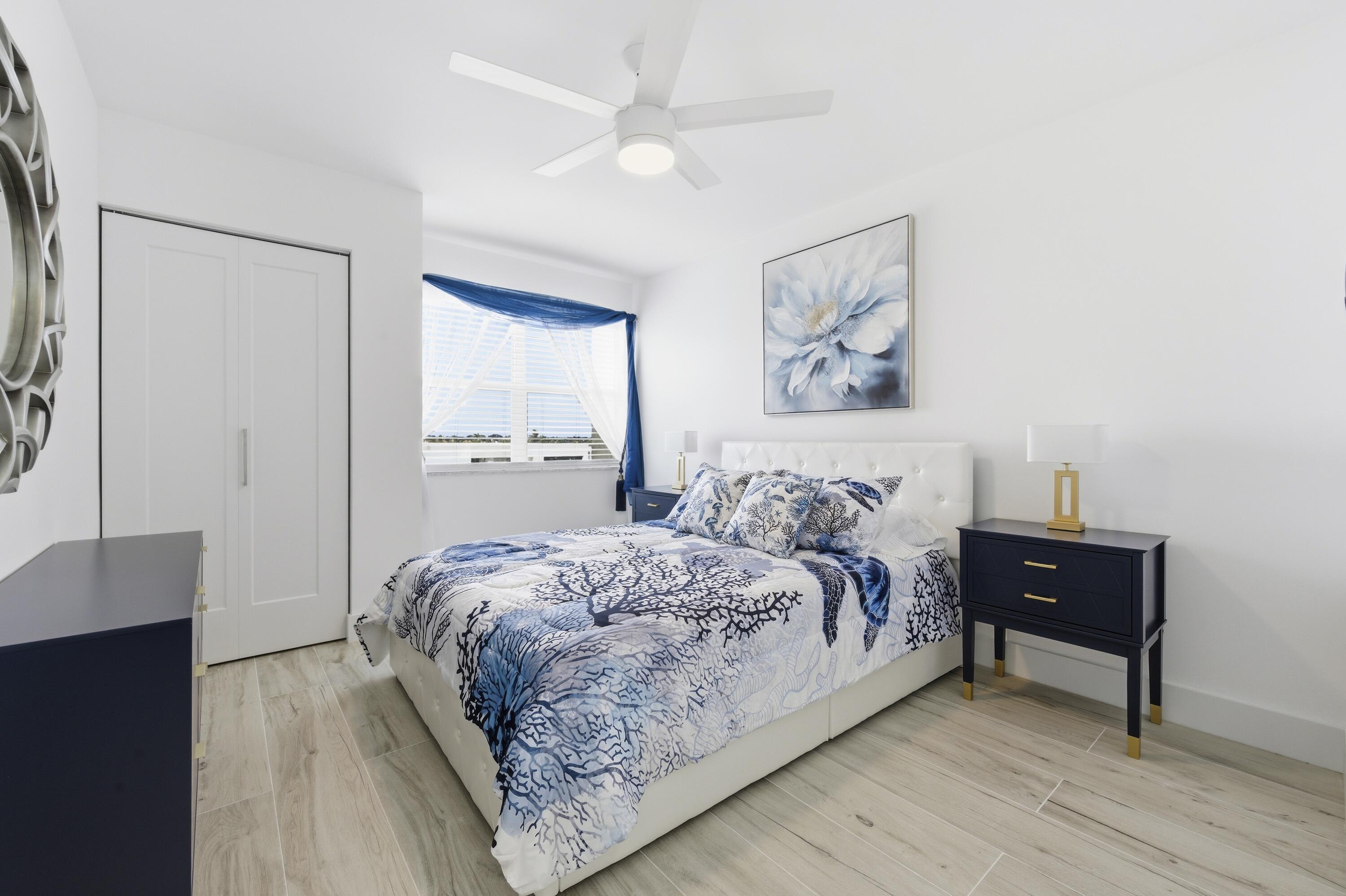 3520 South Ocean Boulevard, Unit H502 South Palm Beach, FL 33480 - Photo 22 of 35 a bedroom with a bed and a table