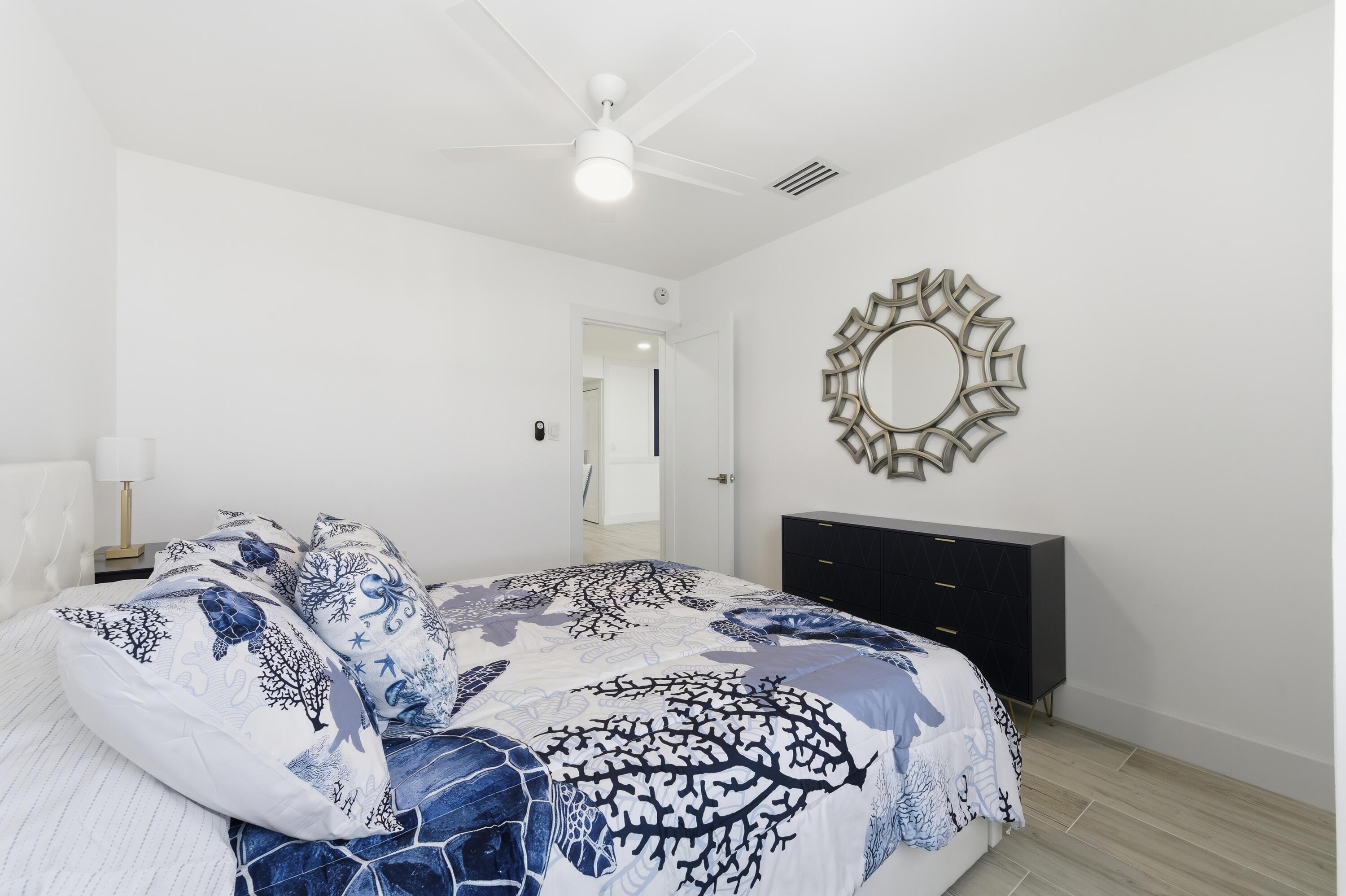 3520 South Ocean Boulevard, Unit H502 South Palm Beach, FL 33480 - Photo 23 of 35 a bedroom with a bed and wooden floor
