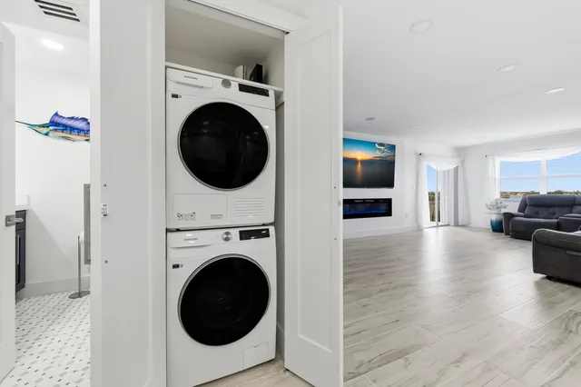 a view of a livingroom with furniture washer and dryer