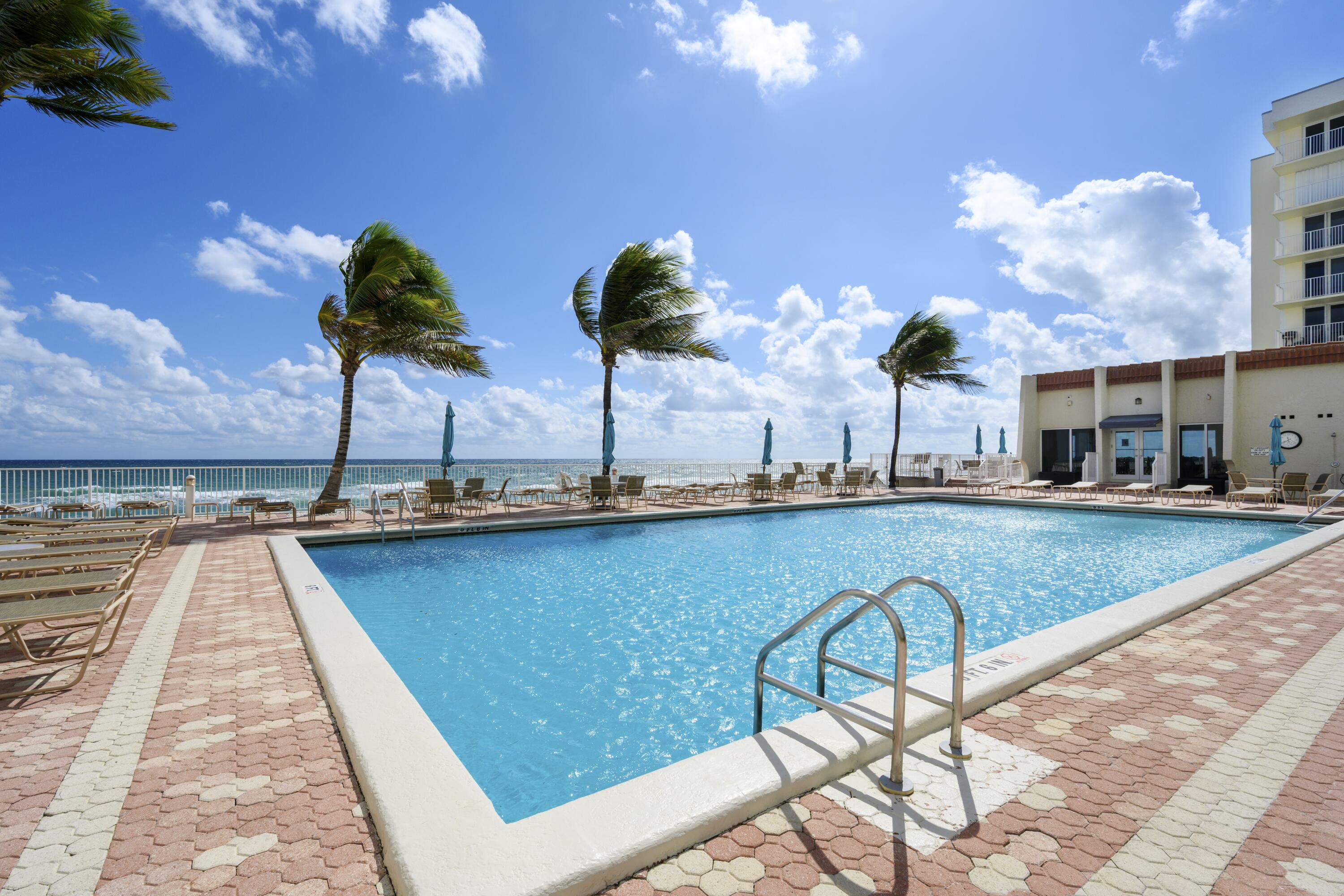 3520 South Ocean Boulevard, Unit H502 South Palm Beach, FL 33480 - Photo 29 of 35 a view of a swimming pool with a lounge chairs