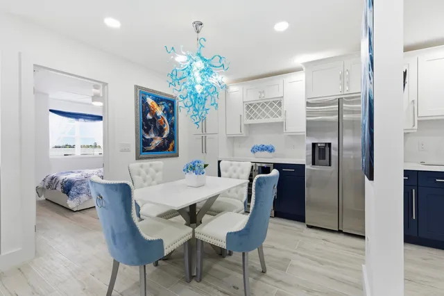 a view of a dining room with furniture and chandelier
