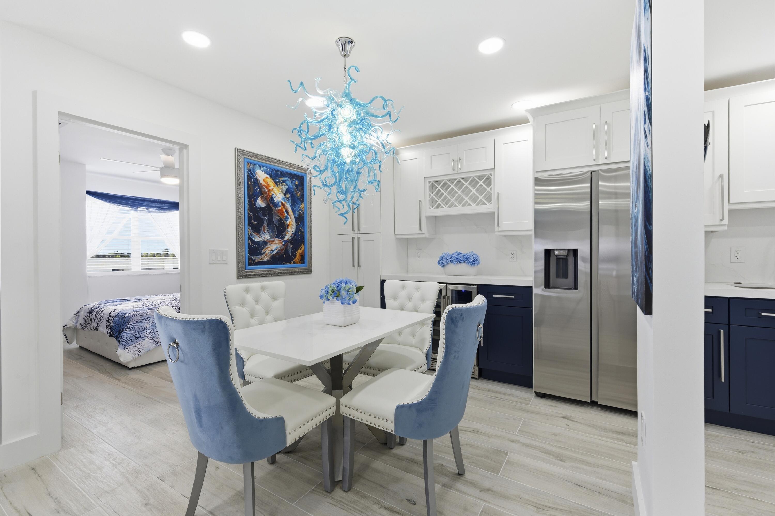 3520 South Ocean Boulevard, Unit H502 South Palm Beach, FL 33480 - Photo 3 of 35 a view of a dining room with furniture and chandelier