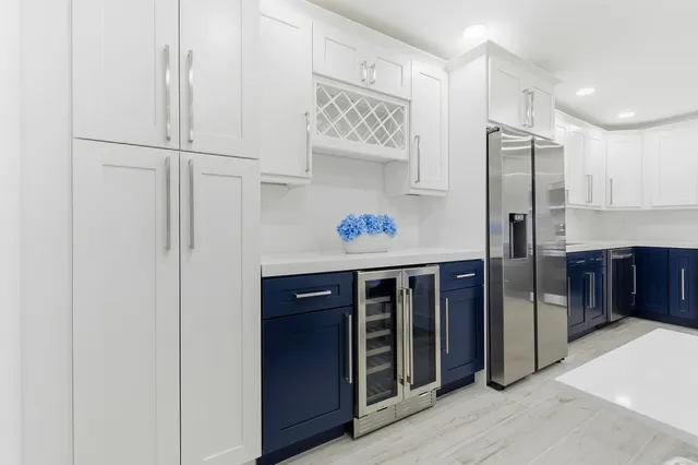 a kitchen with stainless steel appliances a refrigerator and cabinets