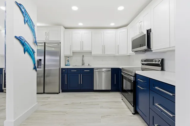 a kitchen with stainless steel appliances granite countertop a refrigerator sink and microwave