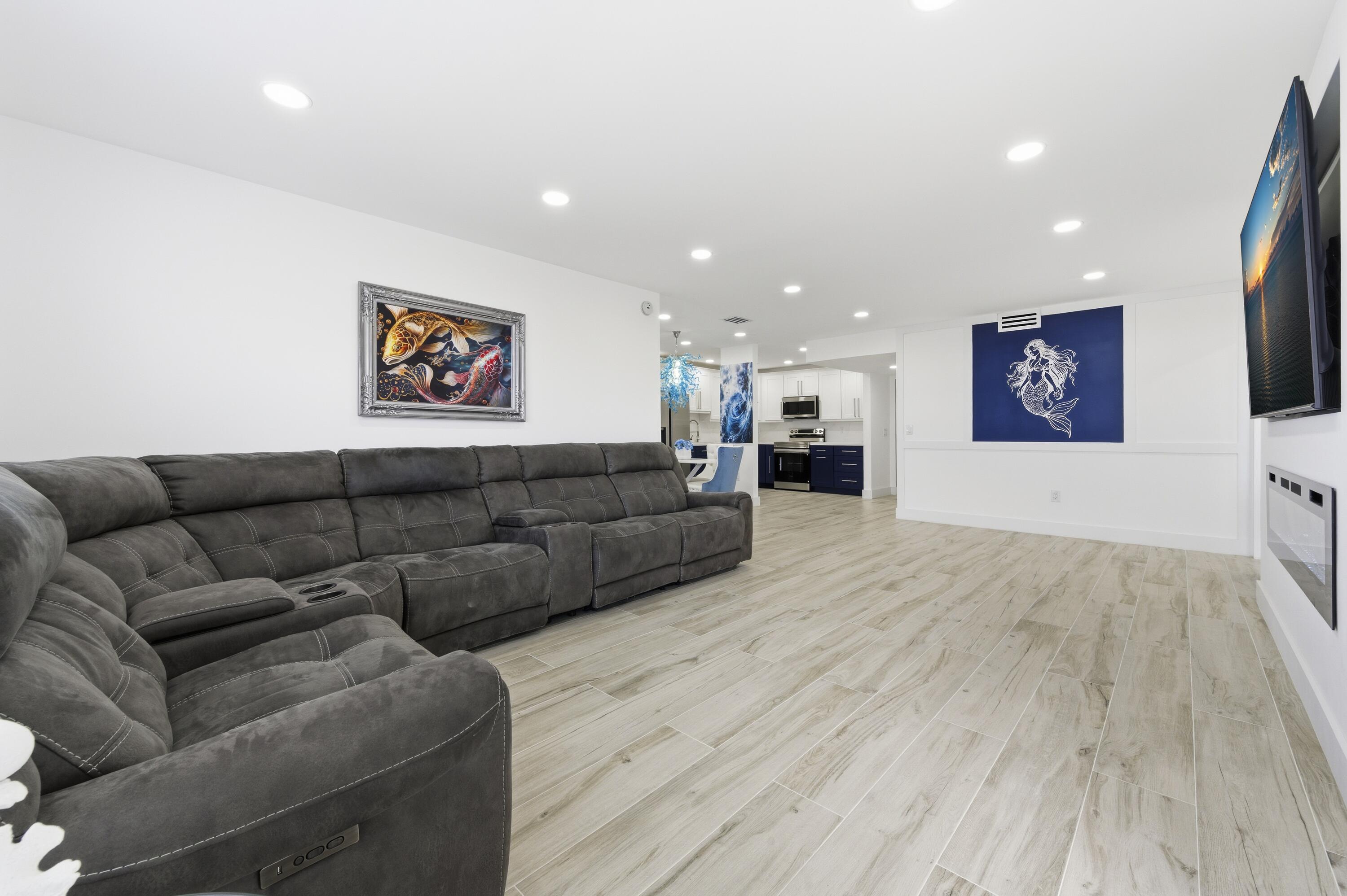 3520 South Ocean Boulevard, Unit H502 South Palm Beach, FL 33480 - Photo 7 of 35 a living room with furniture and a flat screen tv