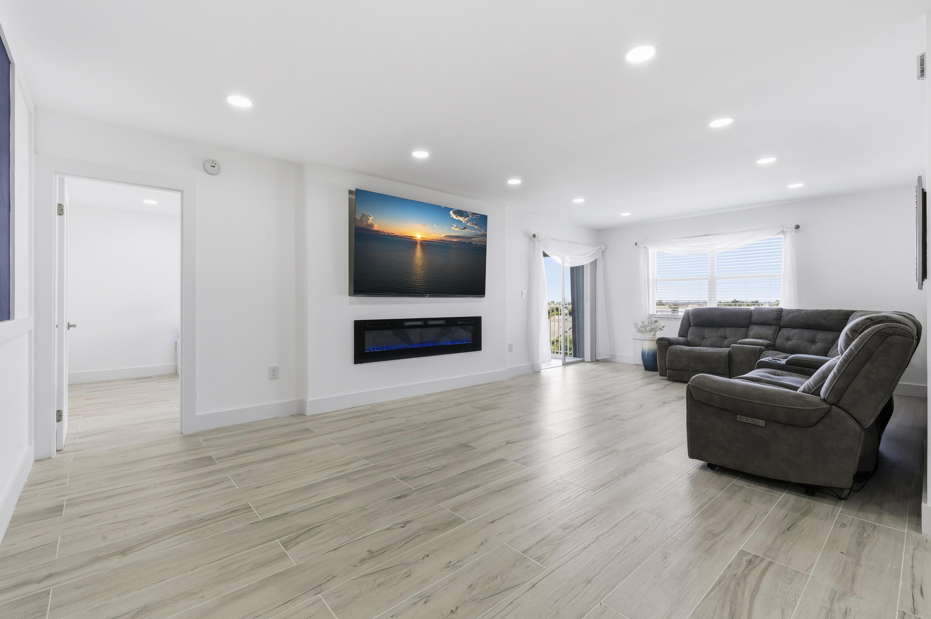 3520 South Ocean Boulevard, Unit H502 South Palm Beach, FL 33480 - Photo 9 of 35 a living room with furniture and a flat screen tv