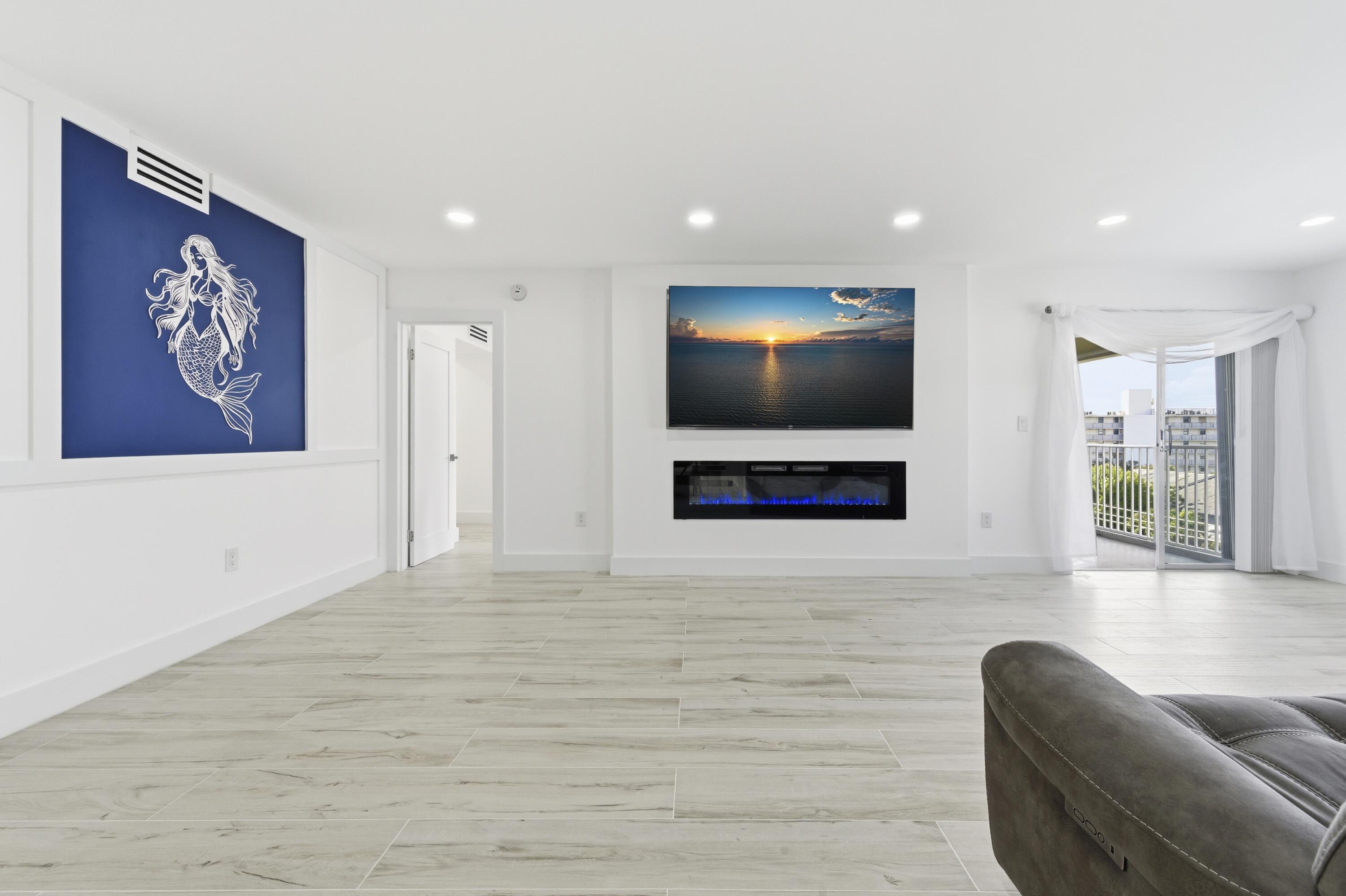 3520 South Ocean Boulevard, Unit H502 South Palm Beach, FL 33480 - Photo 10 of 35 a living room with furniture and a flat screen tv