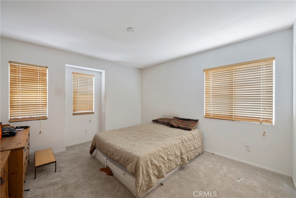 3819 St Austell Way Perris, CA 92571 - Photo 33 of 64 a bedroom with a bed and a window