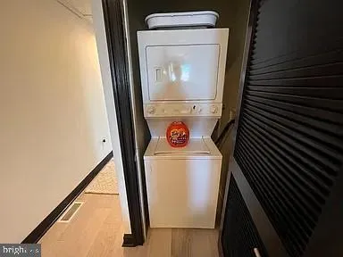 a bedroom with a bed dresser and wooden floor